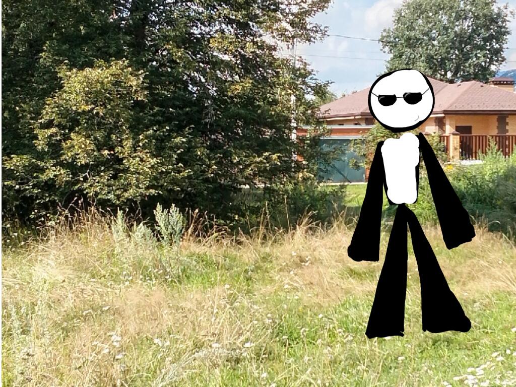 Стикер в очках стоит на заднем плане, на котором изображена деревня с домом и кустами